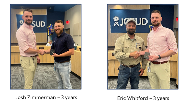 Photo of staff members receiving an award from the JCSUD General Manager