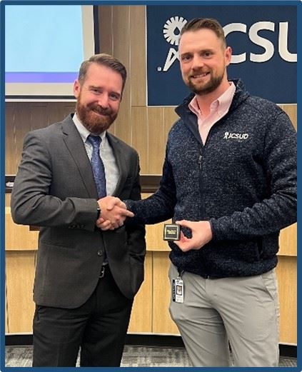 Staff member being presented with award