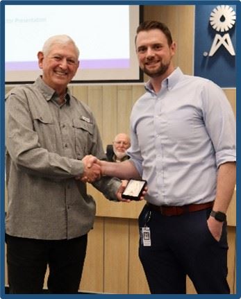 JCSUD employee receiving a service award from a board member