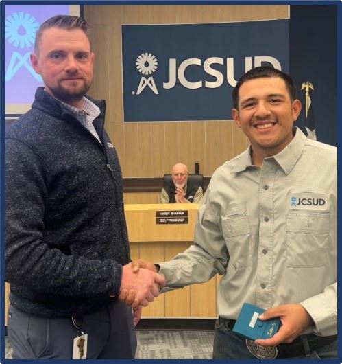 Staff member being presented with an award by General Manager